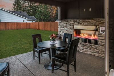 Cozy outdoor seating area with a modern fireplace.