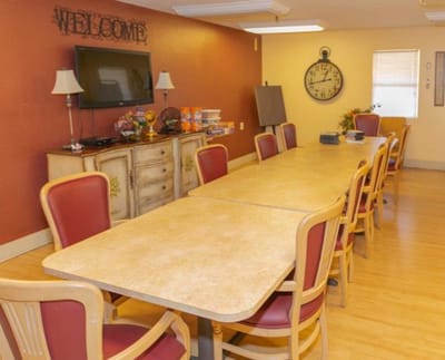 Common area with tables and chairs for gatherings.