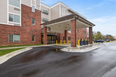 Front entrance of the assisted living facility with a covered drop-off area.