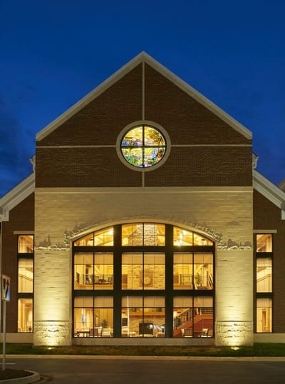 Exterior view of the facility with illuminated windows.