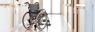 Empty wheelchair in a facility hallway