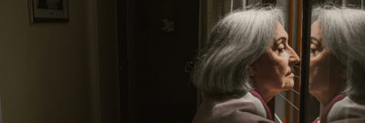 Older woman gazing into a mirror