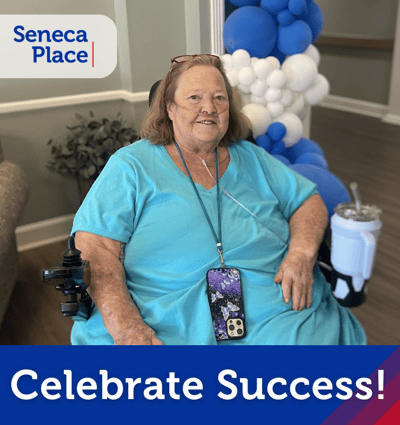 Resident celebrating success in a common area.