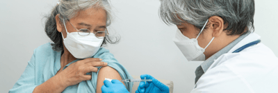 Resident receiving a vaccination from a healthcare professional.