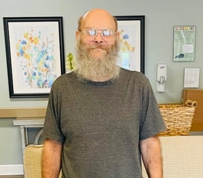 Resident with a beard in a common area