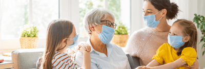 Family interacting with a resident in a cozy interior space.