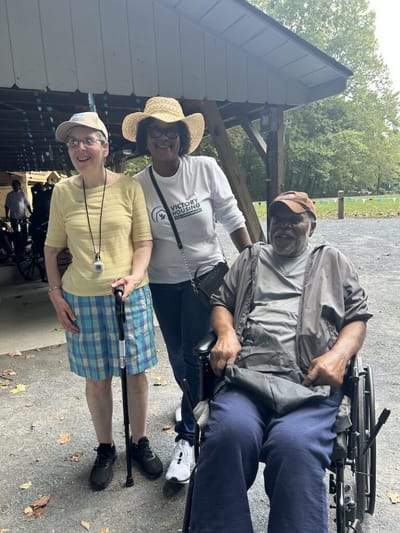 Residents enjoying time outdoors with staff.