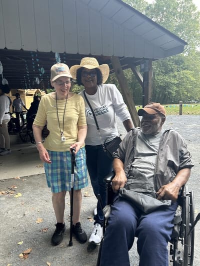 Residents enjoying time outdoors with staff.