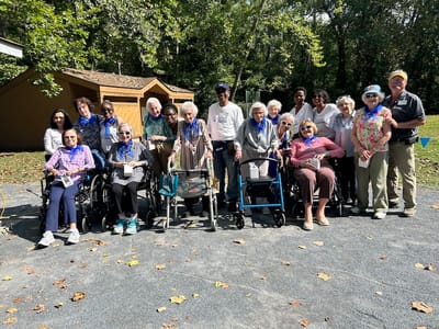 Group of residents and staff celebrating outdoors