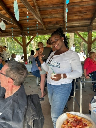 Guest enjoying an outdoor meal at a gathering.