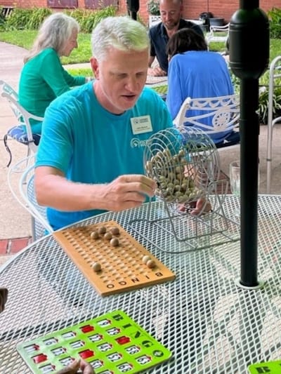 Residents enjoying a game of bingo outdoors.
