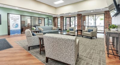 Well-furnished common area with seating and natural light