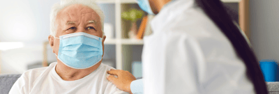 Healthcare worker interacting with senior resident.