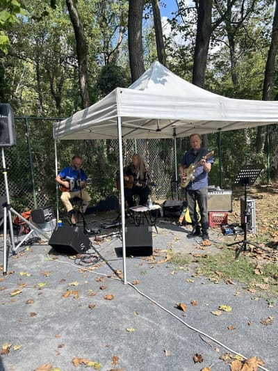 Musicians performing under a tent outside