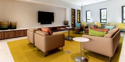 Bright common area with seating and television.