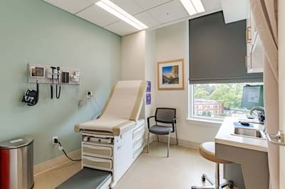 A clinical examination room with medical equipment.
