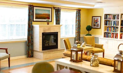 Comfortable common area with fireplace and bookshelves