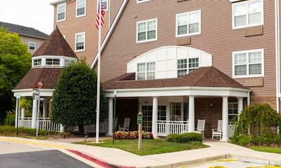 Building exterior with porch and landscaping.