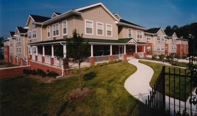 Exterior view of the facility with landscaping and pathway.