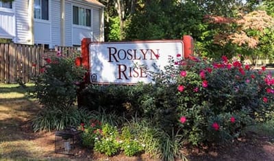 Sign for Roslyn Rise surrounded by flowers