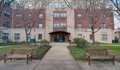 Outdoor view of the main entrance with benches.