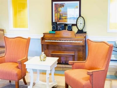 Cozy interior seating area with a piano and decor.