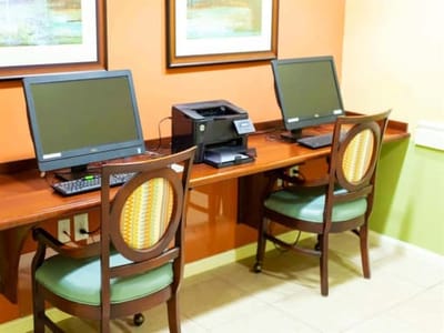 Two computers and a printer in a common space