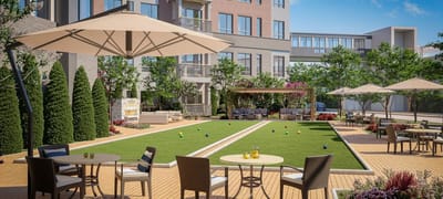 Outdoor area with seating and lawn for activities.