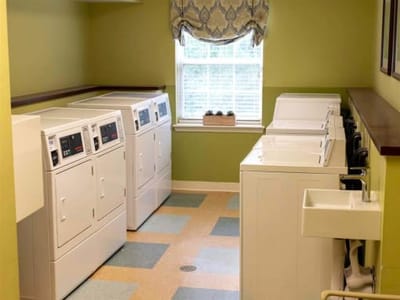 Laundry room with washing machines and dryers