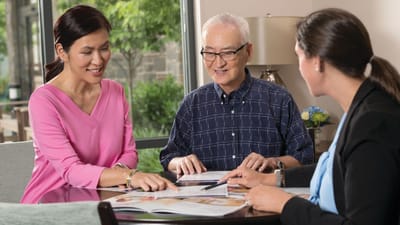 Staff and a resident engaging at a table.