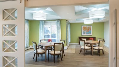 Bright and inviting common area with tables and chairs.