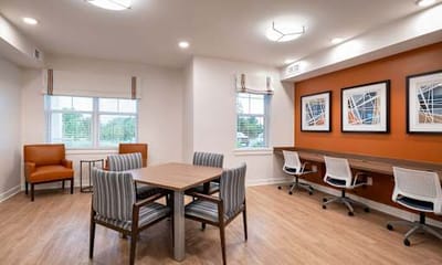 Well-lit common area with seating and workspaces.