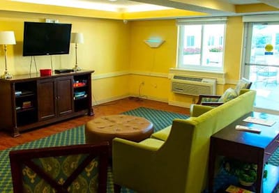 Cozy lounge area with seating and TV.