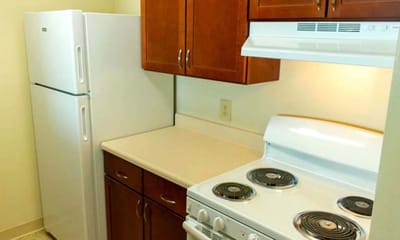 Modern kitchen area with appliances and cabinets