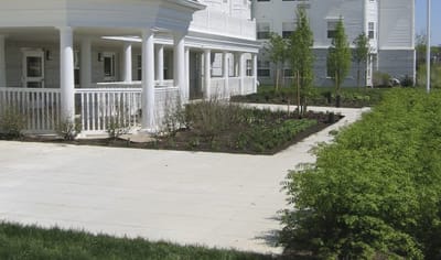 Outdoor space with gardens and building exterior.