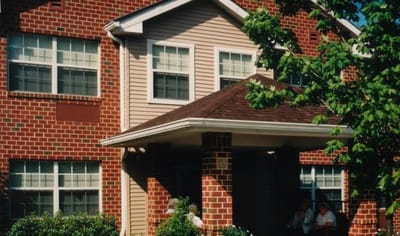 Exterior view of the facility with residents outdoors.