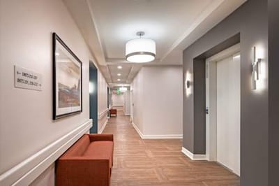 Interior hallway with seating and elevator