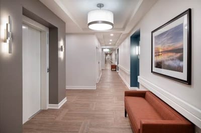 Bright hallway with artwork and seating area