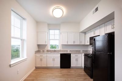 Modern kitchen area with appliances and countertops.