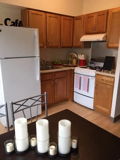 Bright kitchen area with candles and appliances.