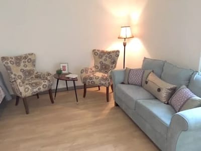 Comfortable seating area with lamps and decor.