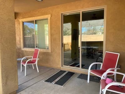 Patio area with chairs and sliding glass door