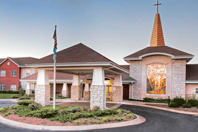 Exterior view of the facility entrance with a cross