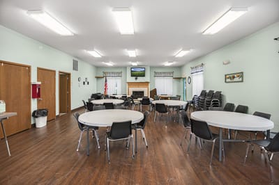 Interior view of a spacious common area with tables and chairs