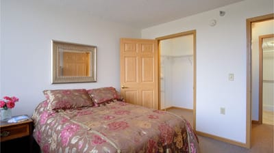 Cozy private bedroom with floral bedding and closet