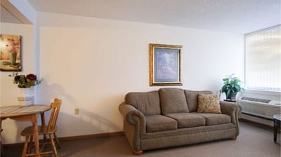 Cozy living room area with couch and artwork
