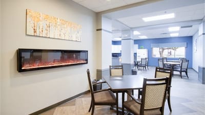 Bright common area with seating and a fireplace