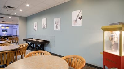 Common area with seating, artwork, and a popcorn machine