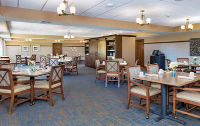 Bright dining room with tables set for meals