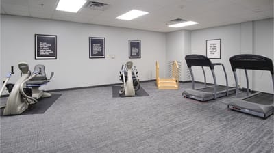 Fitness room with exercise equipment and motivational posters